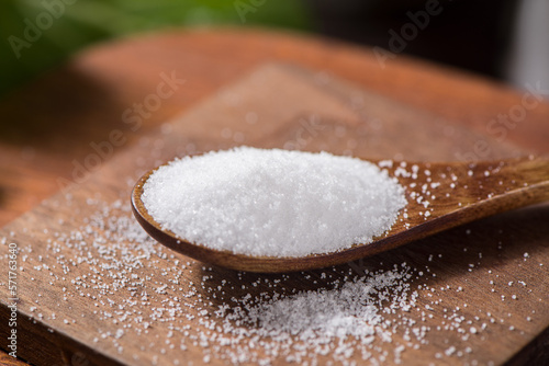 close up of salt in wooden spoon on table