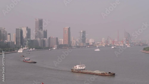 Extreme wide shot of Tokyo Bay with cargo ships sailing and buildings in the background. photo