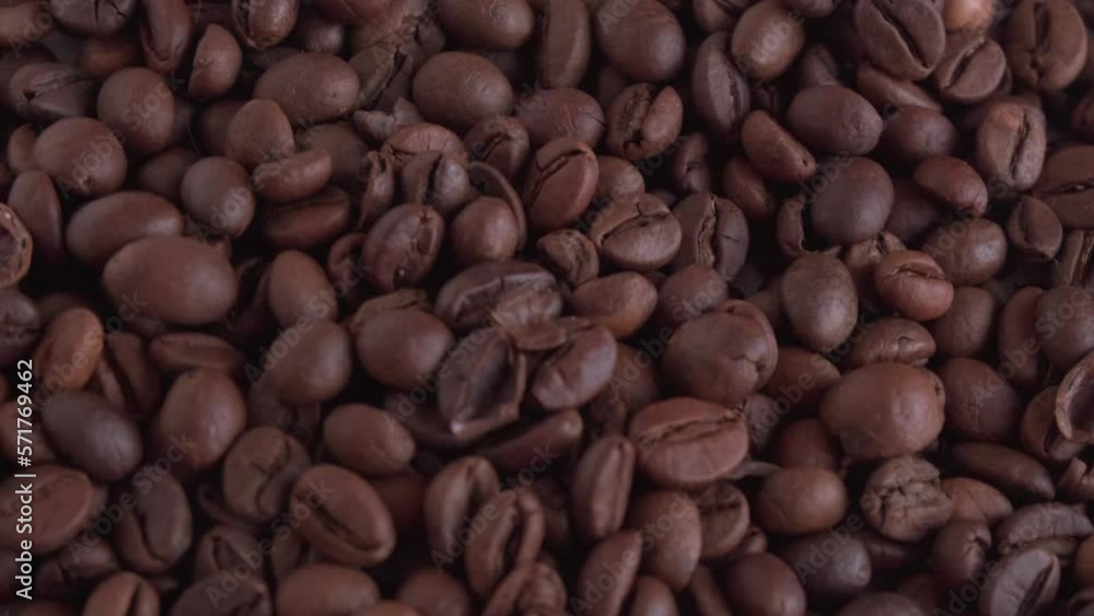Roasted coffee beans are spinning in a circle.Close-up coffee beans rotate. Roasted coffee beans are spinning in a circle.Close-up coffee beans rotate.