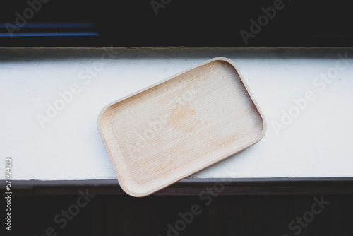 Fototapeta Naklejka Na Ścianę i Meble -  Wood tray or wood coaster on white cement in the restaurant.