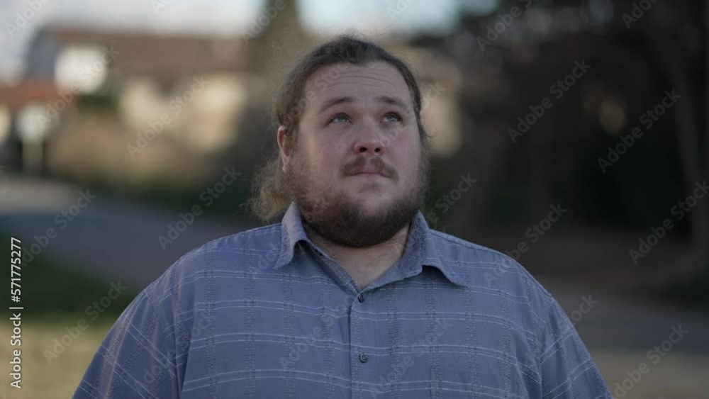 One hopeful young overweight man looking up at sky with FAITH and GRATITUDE. Happy male caucasian person close up face feeling the presence of GOD One hopeful young overweight man looking up at sky with FAITH and GRATITUDE. Happy male caucasian person close up face feeling the presence of GOD