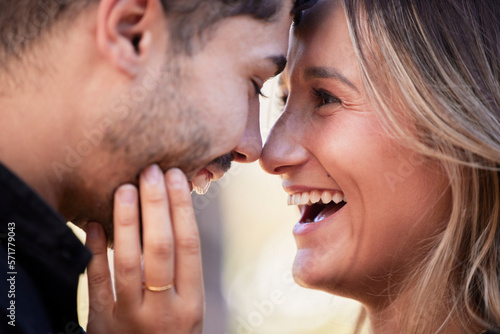 Couple, forehead touch and laugh together with happiness, comic moment or romance outdoor for date. Man, woman and funny time with love, care or happy in nature closeup with hand, face and crazy joke