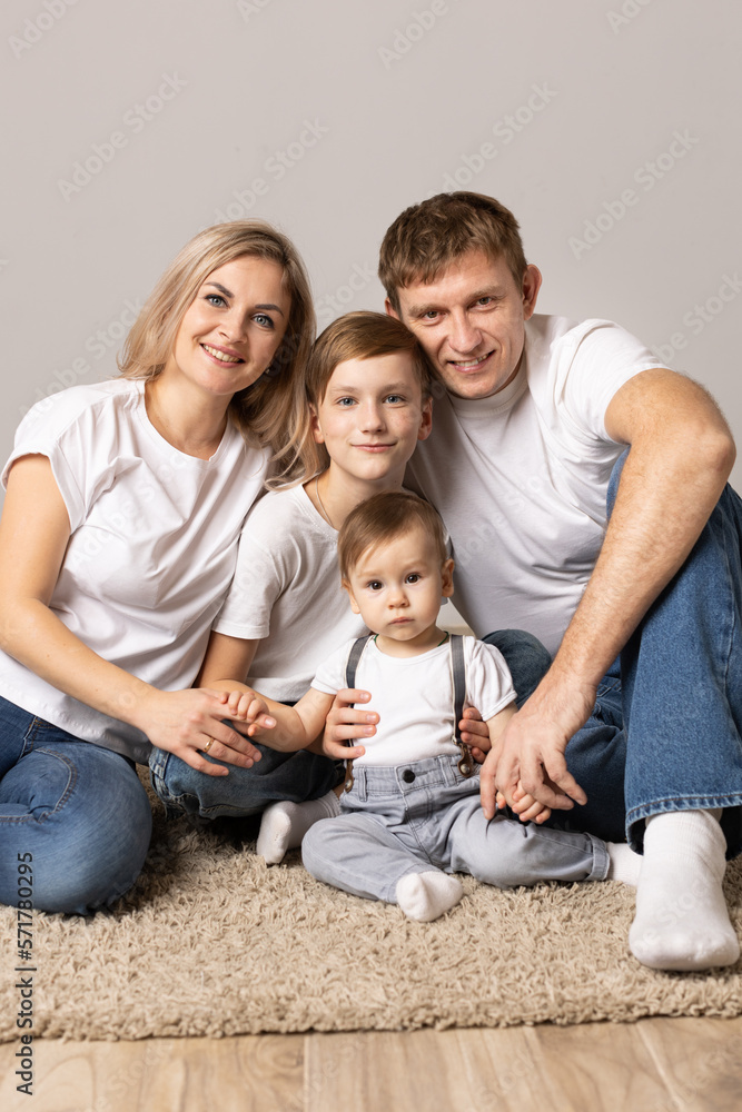 family with children on gray background