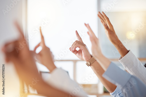 Seminar, diversity and business people raise hands to ask a question at training in the office. Group, multiracial and professional employees at a corporate tradeshow or conference in the workplace. photo