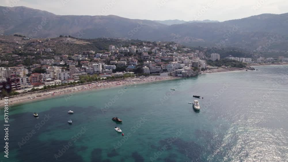 Aerial of boats calmly resting on the azure bay of Himara, Albania Aerial of boats calmly resting on the azure bay of Himara, Albania