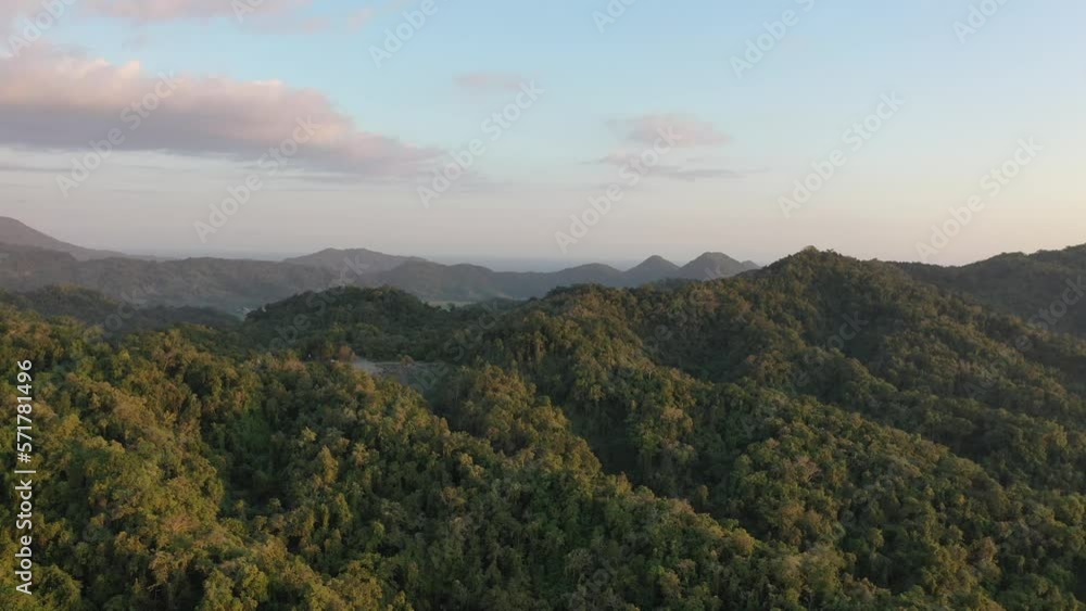 Drone shot over Sumbawa's jungle, power towers and highway. Drone shot over Sumbawa's jungle, power towers and highway.