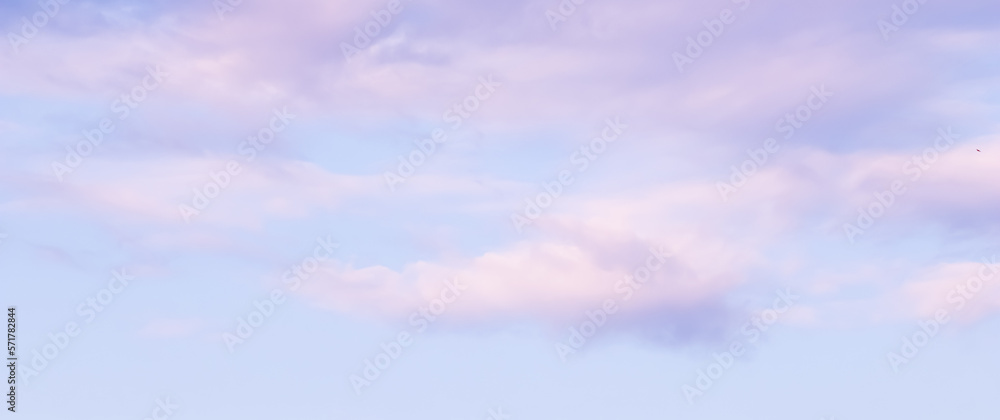 Blue sky background with white and pink clouds at sunset