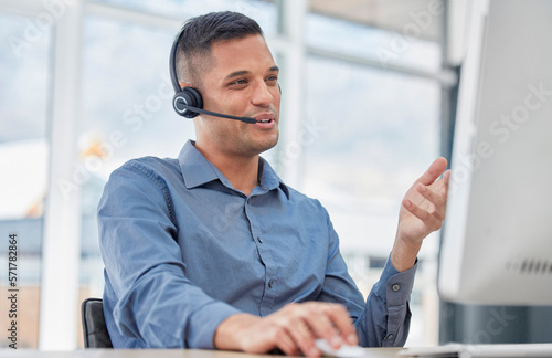 Customer support, call center and male telemarketing consultant doing a consultation online. Contact us, communication and man customer service agent with a headset working on crm strategy in office. photo