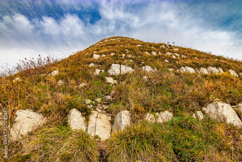 Large stones on the slope of Mount Peus. Mountain landscape with beautiful Caucasian nature. Panoramic view of the Caucasus mountains. View of the mountain range under a cloudy sky. photo