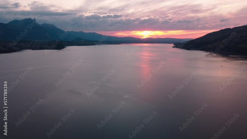 Orbiting view over lake Thun during sunset. Revealing the mountains and town of Merligen. Switzerland, Orbiting view over lake Thun during sunset. Revealing the mountains and town of Merligen. Switzerland,