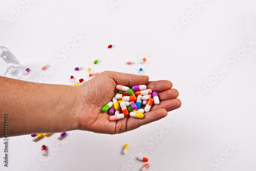 Colorful pills and medicines are placed on the hand. It is separated from the background and can be changed to any color you want.