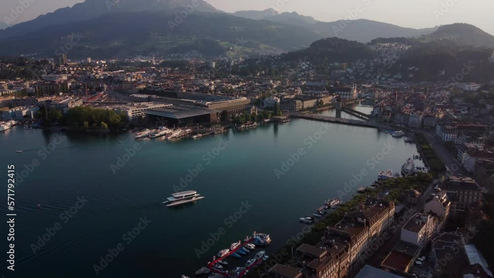 Aerial view of the harbor of Lucern on Vierwaldstättersee lake. Showing a modern katamaran ferry approaching the city. Switzerland, canton Lucern Aerial view of the harbor of Lucern on Vierwaldstättersee lake. Showing a modern katamaran ferry approaching the city. Switzerland, canton Lucern
