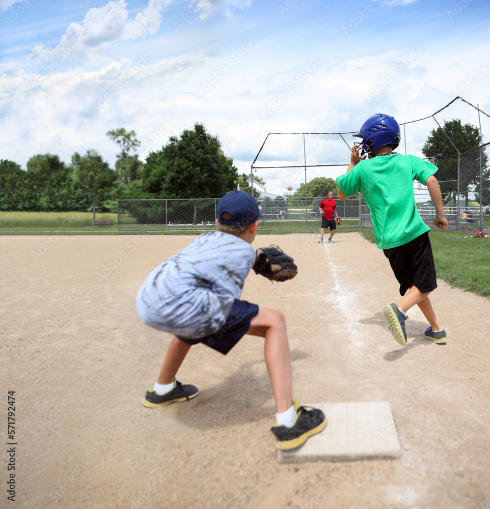 Baseball practice, coach throwing to third base catching runner in a ...