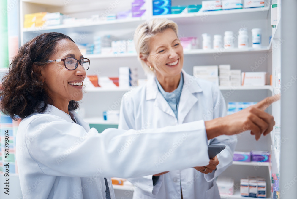 Pharmacy women, shelf and pointing together with smile, stock and product for medical wellness in store. Pharmacist training, management and teamwork for medicine, service and healthcare in shop
