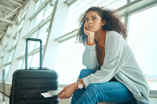 Φωτογραφία Airport, travel delay and sad woman with anxiety for immigration, passport problem or schedule
