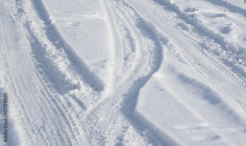 Track from the car on white snow into the distance.