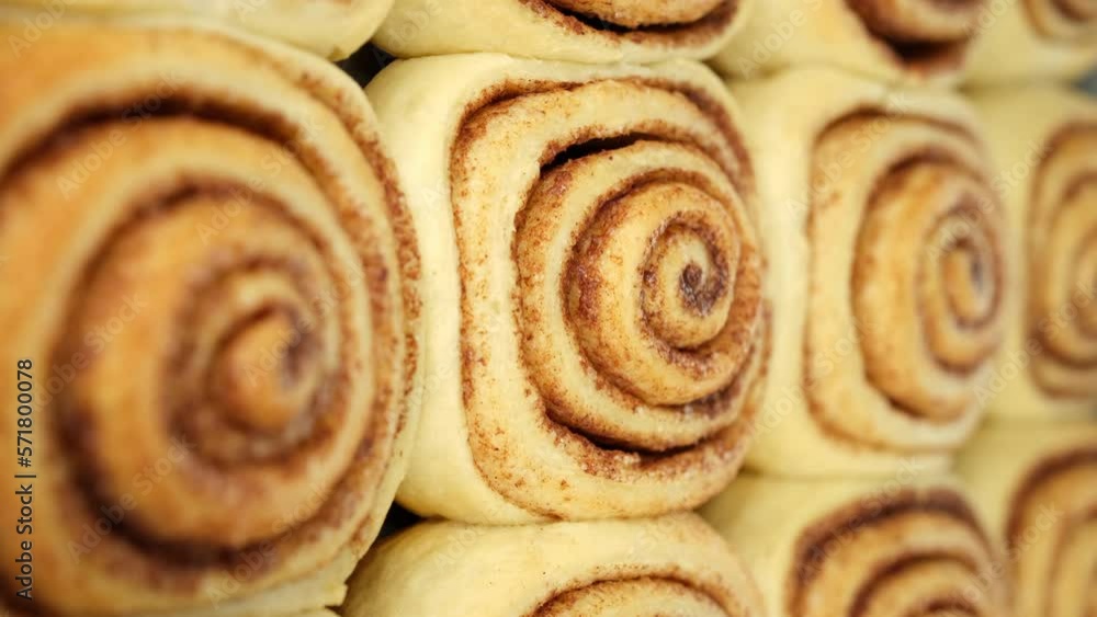 Freshly baked cinnamon rolls or Cinnabon close up. Vertical video Freshly baked cinnamon rolls or Cinnabon close up. Vertical video
