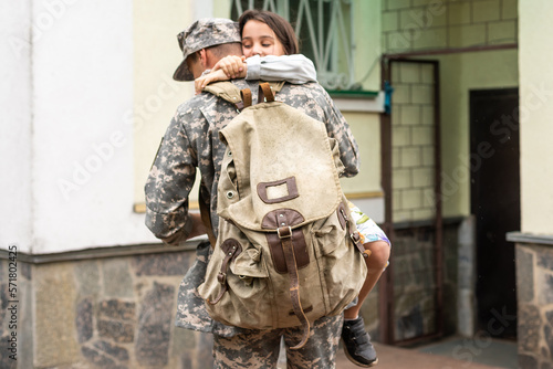 Happy little girl having fun with her military father