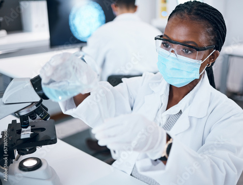 Science, covid and reaction with a black woman doctor working in a laboratory for research or innovation. Medical, analytics and development with a female scientist at work in a lab for chemistry