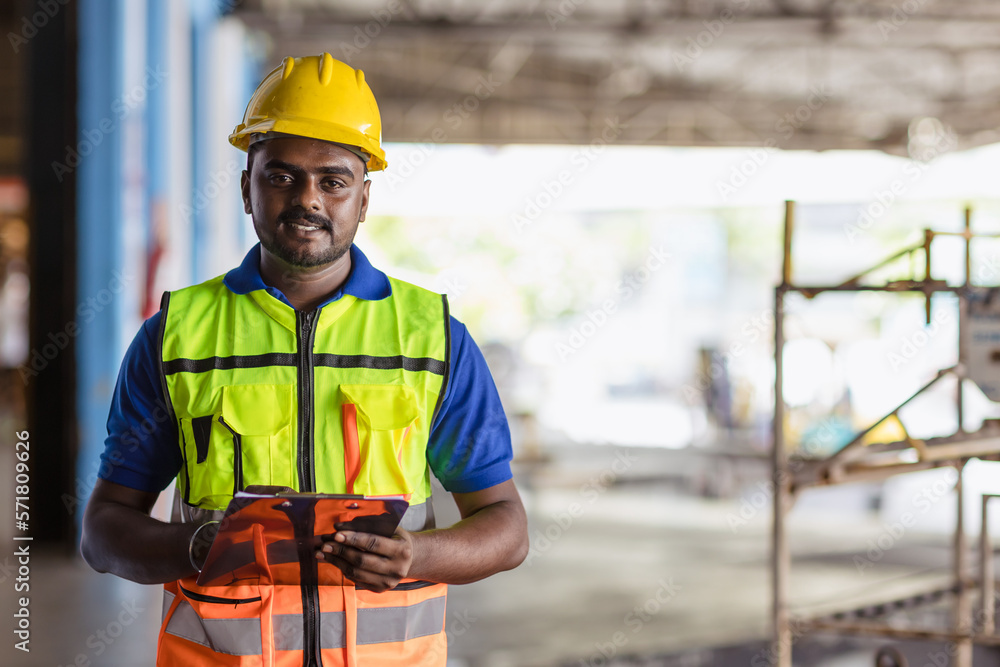 Portrait Indian male staff worker engineer supervisor in safety suit work in factory warehouse Portrait Indian male staff worker engineer supervisor in safety suit work in factory warehouse