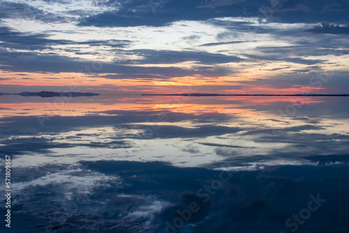Scenic view of beautiful water reflections in lake of Bonneville Salt Flats at sunrise, Wendover, Western Utah, USA, America. Dreamy clouds mirroring on the water surface creating romantic atmosphere
