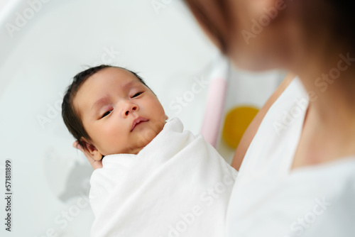 mother prepare to give a bath and wash newborn baby hair in bathtub