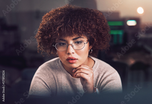 Black woman, face and night business in dark office with glasses for reading or data analysis. Software engineer, IT technician or developer thinking at computer for research on programming or coding
