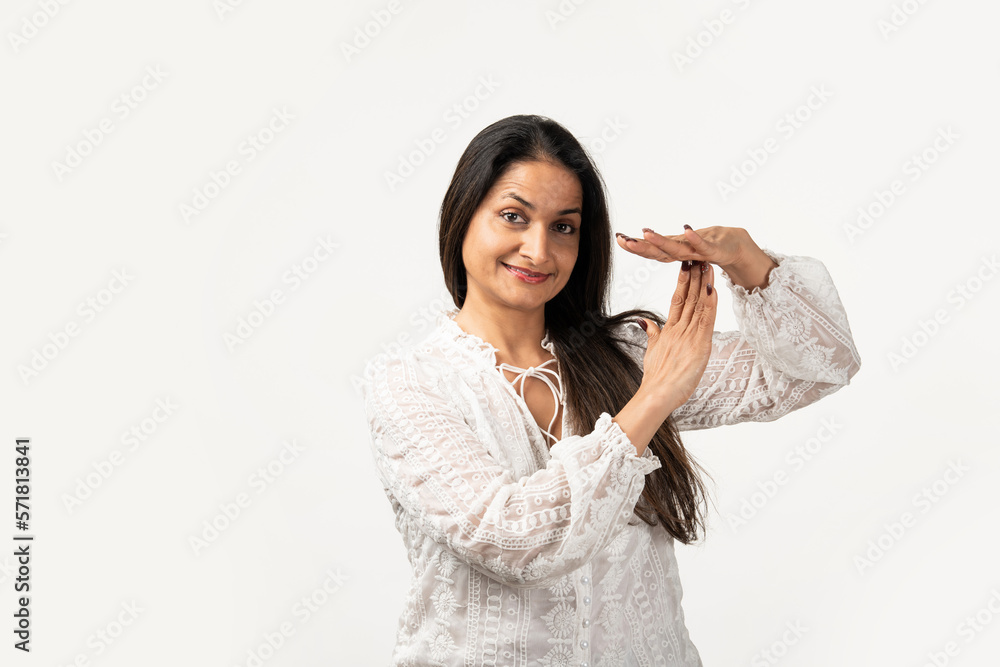 Indian mid age serious woman showing a time out gesture with hands, isolated white background Indian mid age serious woman showing a time out gesture with hands, isolated white background
