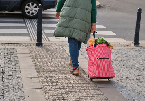 Woman food Shopping trolley bag wheeled shopping bag crossing city street