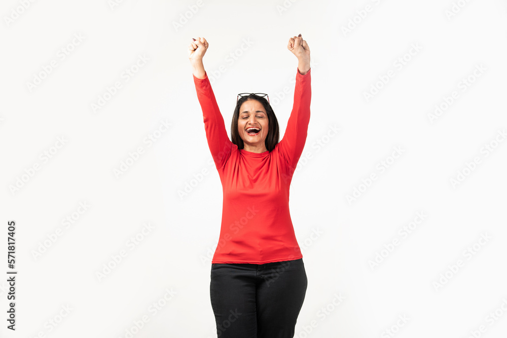 Confident Indian woman rejoicing, looking happy and celebrating victory, fist pump gesture Confident Indian woman rejoicing, looking happy and celebrating victory, fist pump gesture