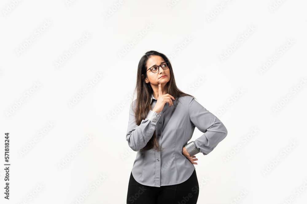portrait of Indian beautiful woman thinking looking and smiling having a finger at her chin portrait of Indian beautiful woman thinking looking and smiling having a finger at her chin