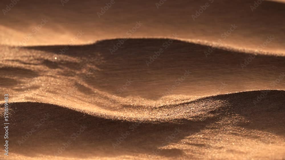 Sand blowing over dunes in wind, sandstorm in Gobi desert, close up Sand blowing over dunes in wind, sandstorm in Gobi desert, close up
