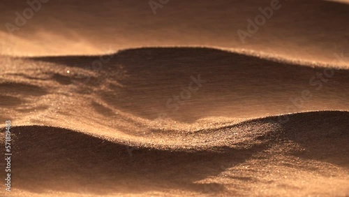 Sand blowing over dunes in wind, sandstorm in Gobi desert, close up photo