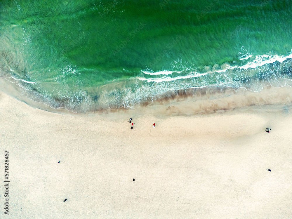 Aerial view landscape, seascape. Sea, ocean, water, sand , beach, walking people. Photo from a drone.