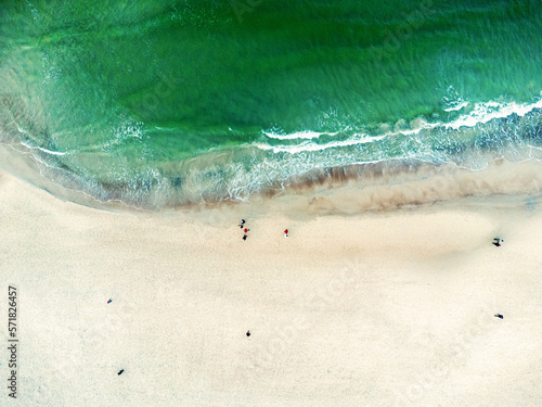 Obraz na płótnie Aerial view landscape, seascape. Sea, ocean, water, sand , beach, walking people. Photo from a drone. w salonie