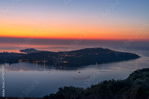 View of sunrise over Villefranche sur mer with Saint Jean Cap Ferrat, Cote d'Azur, South of France, Europe
