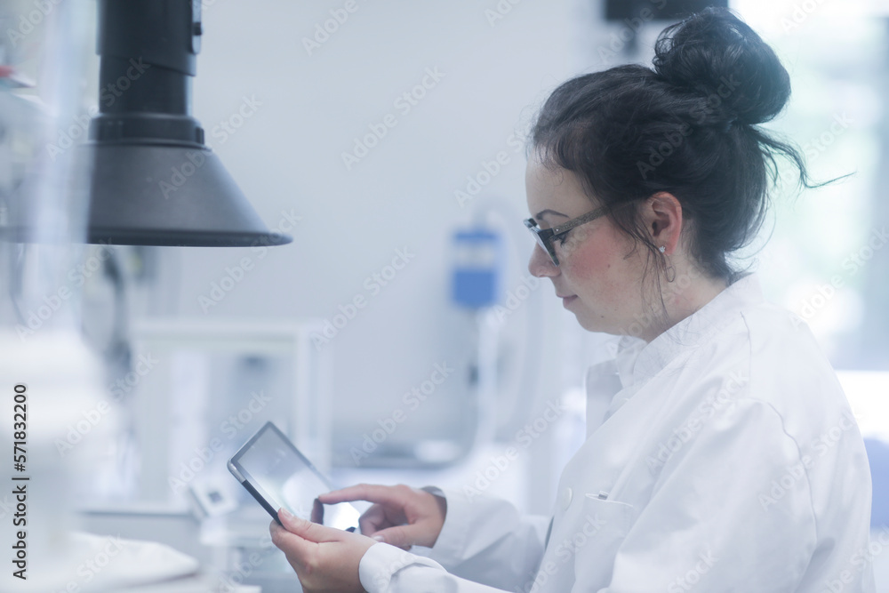 young scientist female with tablet in a laboratory young scientist female with tablet in a laboratory
