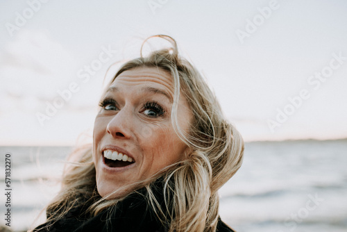 portrait of happy woman by the ocean photo