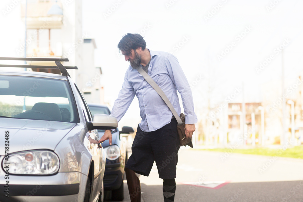older man with prosthetic leg opening car older man with prosthetic leg opening car