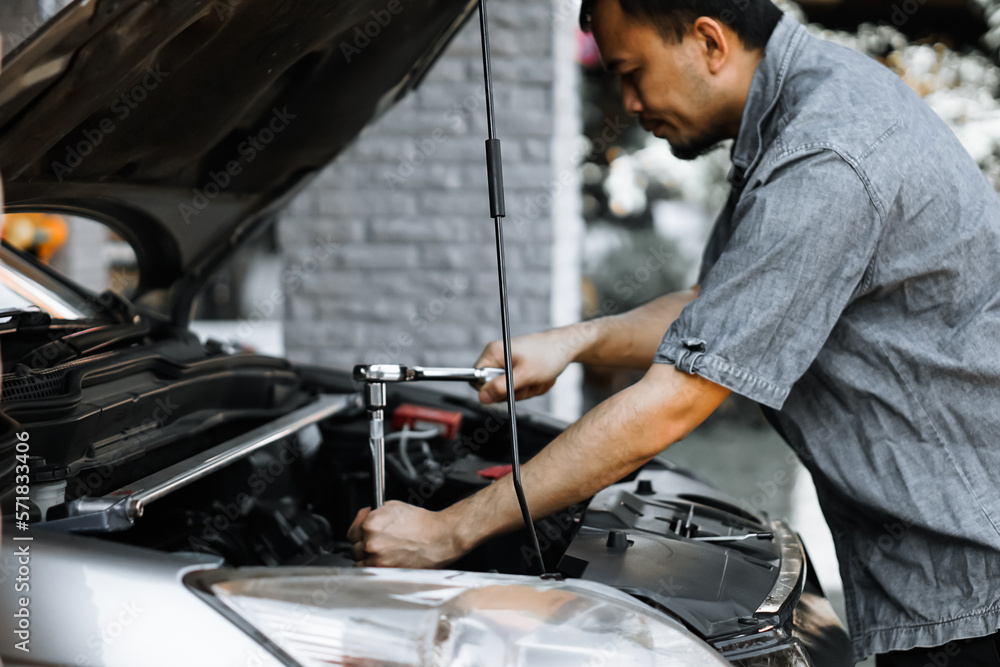 Auto mechanic working in garage. Repair service.
Auto mechanic working in garage. Repair service.