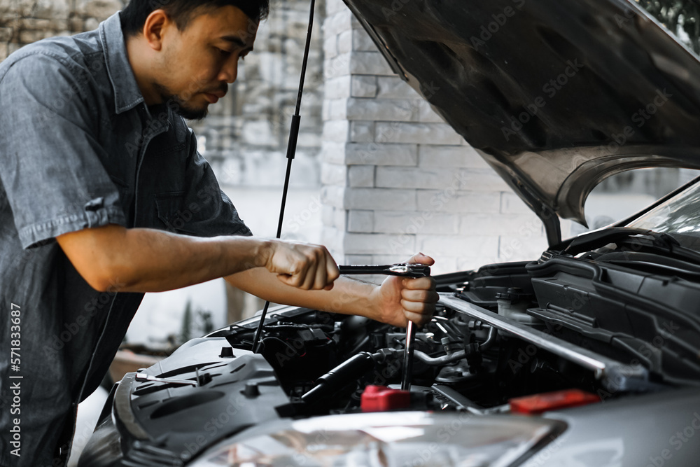 Auto mechanic working in garage. Repair service.
Auto mechanic working in garage. Repair service.