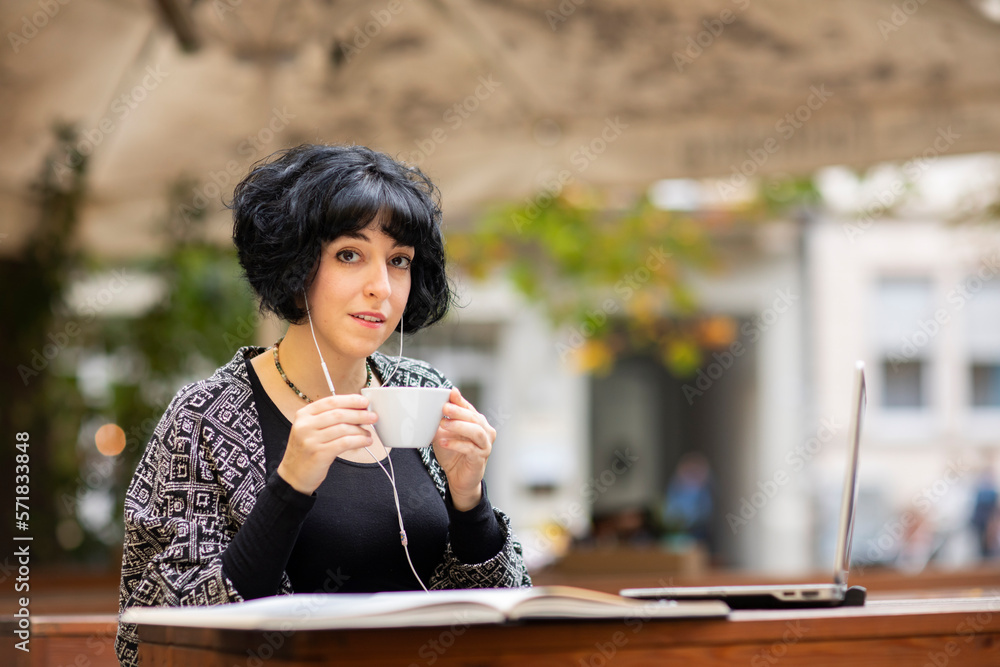 young woman with laptop outside drinking coffee young woman with laptop outside drinking coffee