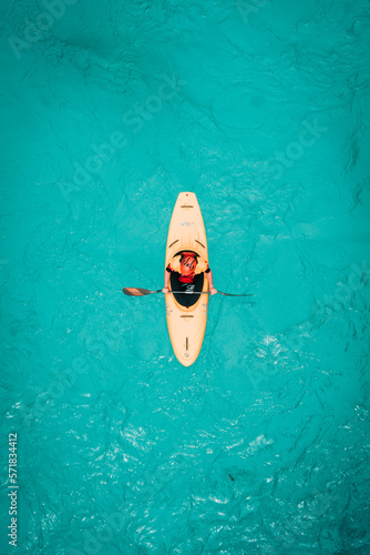 medium framed shot from above of kayaker in teal water photo