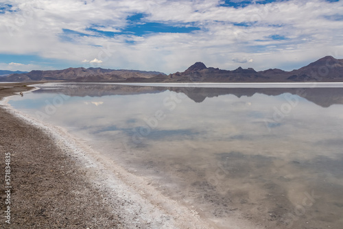 Panoramic view of beautiful mountains reflecting in lake of Bonneville Salt Flats, Wendover, Western Utah, USA, America. Looking at summits of Silver Island Mountain range. West of Great Salt Lake photo