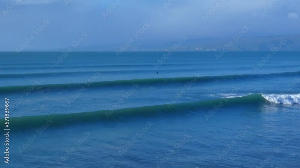 Lone surfer waiting for wave is just visible on a beautiful mid-winter's morning - New Brighton Beach, Christchurch (New Zealand) Lone surfer waiting for wave is just visible on a beautiful mid-winter's morning - New Brighton Beach, Christchurch (New Zealand)