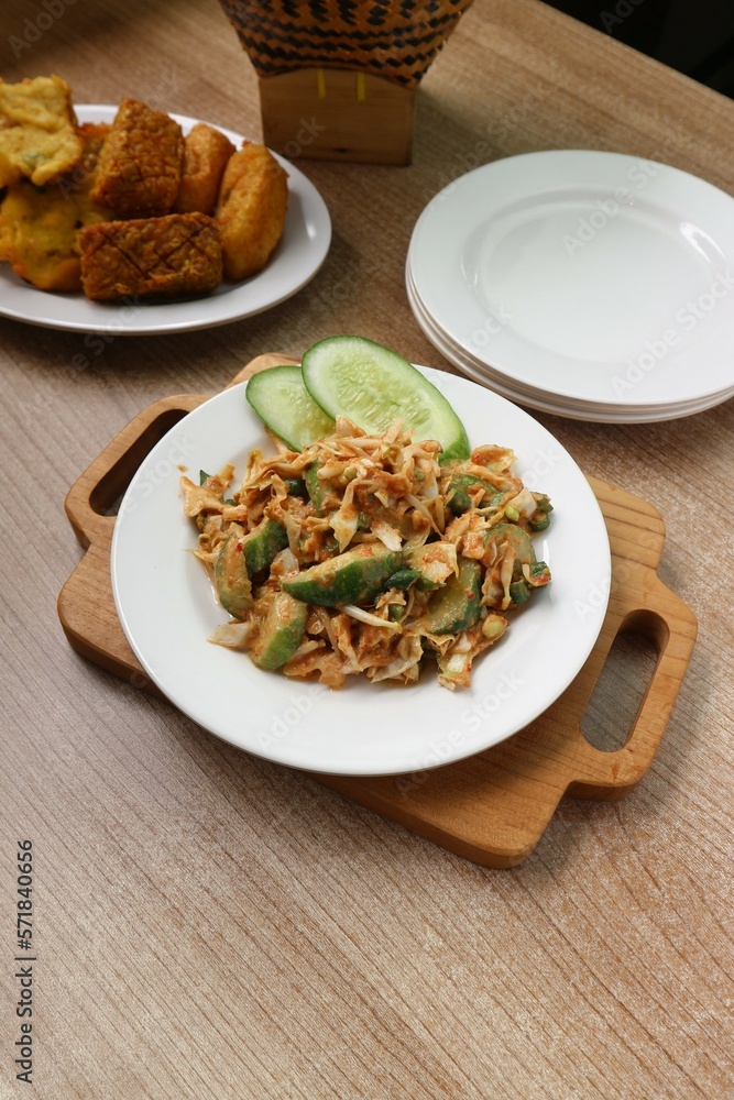 serving of fresh vegetables with spicy peanut sauce on a white plate