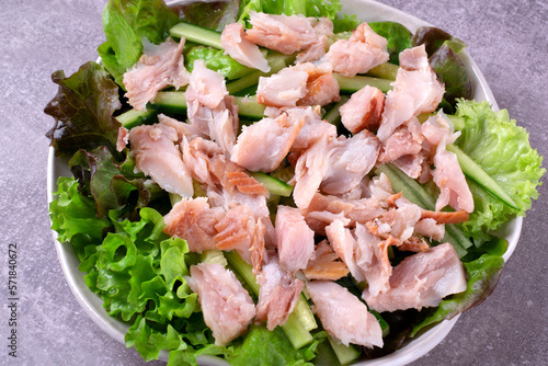 Salad with hot smoked catfish clarias, cucumber and lettuce dressed with lemon juice, soy sauce, honey and olive oil