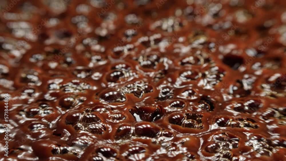 Boiling brown substance, macro shot, shallow focus, real-time. Boiling brown substance, macro shot, shallow focus, real-time.