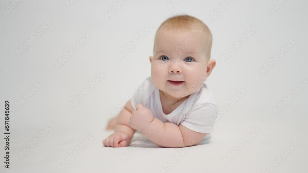 Portrait of a contented baby on a white background, concept stages of becoming a human being in a newborn state Portrait of a contented baby on a white background, concept stages of becoming a human being in a newborn state
