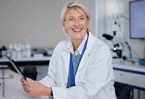 Portrait, doctor and senior woman with tablet in laboratory for science or medical research. Scientist, technology and smile of happy elderly female researcher from Canada holding digital touchscreen